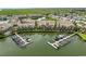 Aerial view of waterfront condos with private boat docks, manicured lawns, and tranquil waterway at 4304 Harbor House Dr, Tampa, FL 33615