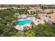 Aerial shot featuring community pool with lounge chairs, surrounded by lush landscaping in a residential area at 4304 Harbor House Dr, Tampa, FL 33615