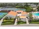 Aerial view of condos with a landscaped courtyard, mature palms, and amenities including a pool and tennis court at 4304 Harbor House Dr, Tampa, FL 33615