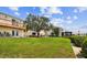 Manicured lawn leading to the waterfront, showing patio, landscaping, and building exterior at 4304 Harbor House Dr, Tampa, FL 33615