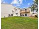 Spacious backyard with lawn, patio seating, and a balcony overlooking the green space at 4304 Harbor House Dr, Tampa, FL 33615