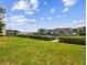 Expansive lawn with waterfront views, boat docks, and lush greenery on a sunny day at 4304 Harbor House Dr, Tampa, FL 33615