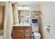 Bathroom with a wooden vanity, ample lighting, a shower-tub combo and decorative shelving at 4304 Harbor House Dr, Tampa, FL 33615