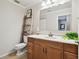This bathroom features a vanity with a wood cabinet, a white sink, and a large mirror at 4304 Harbor House Dr, Tampa, FL 33615