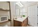 This bathroom features a vanity with a wood cabinet, a white sink, and a large mirror at 4304 Harbor House Dr, Tampa, FL 33615