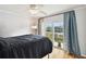 This bedroom features hardwood floors and sliding glass doors that open to a private outdoor balcony at 4304 Harbor House Dr, Tampa, FL 33615
