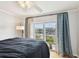 This bedroom features hardwood floors and sliding glass doors that open to a private outdoor balcony at 4304 Harbor House Dr, Tampa, FL 33615