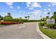 Entrance to Spinnaker Cove with lush tropical landscaping, signage, and a private boating community at 4304 Harbor House Dr, Tampa, FL 33615