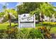 Sign for Spinnaker Cove Condominiums, a private boating community with tropical landscaping and manicured lawns at 4304 Harbor House Dr, Tampa, FL 33615