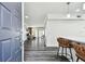 An open foyer with dark floors leads into the living spaces of this home, with bar stool seating for the kitchen at 4304 Harbor House Dr, Tampa, FL 33615