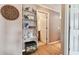 Hallway featuring hardwood floors, decorative shelving, and an open doorway to bathroom at 4304 Harbor House Dr, Tampa, FL 33615