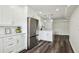 This remodeled kitchen features stainless appliances, white cabinets, and bar stool seating and opens to the living area at 4304 Harbor House Dr, Tampa, FL 33615
