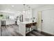 An open kitchen is remodeled with white cabinets, stainless appliances, wood floors, and a side exterior door at 4304 Harbor House Dr, Tampa, FL 33615