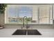 A view of the marina from the kitchen sink window offers a bright, open feeling with plenty of natural light at 4304 Harbor House Dr, Tampa, FL 33615