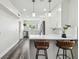 A bright, recently remodeled kitchen features white cabinets, stainless appliances, and bar stool seating at 4304 Harbor House Dr, Tampa, FL 33615
