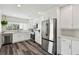 This bright kitchen is updated with white cabinets, stainless appliances, and quartz counters with an undermount sink at 4304 Harbor House Dr, Tampa, FL 33615