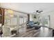 Living room with a ceiling fan, sliding door to patio, and doorway to a hall at 4304 Harbor House Dr, Tampa, FL 33615