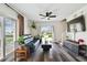 Living room showing slider doors to the yard, wood floors, and a modern ceiling fan at 4304 Harbor House Dr, Tampa, FL 33615
