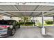 Assigned covered parking area with clearly marked unit numbers and nicely kept landscaping at 4304 Harbor House Dr, Tampa, FL 33615