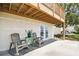 A charming patio with seating underneath a wooden balcony, perfect for outdoor relaxation and enjoyment at 4304 Harbor House Dr, Tampa, FL 33615