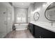 Bright bathroom features a standalone tub, glass enclosed shower, and double vanity with modern fixtures at 10101 Paddock Oaks Dr, Riverview, FL 33569
