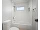 Modern bathroom with white subway tile, shower/tub combo, and black accents provides a clean design at 10101 Paddock Oaks Dr, Riverview, FL 33569