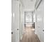 Hallway view into a stunning bathroom featuring a standalone tub under a arched window, and wood-look floors at 10101 Paddock Oaks Dr, Riverview, FL 33569