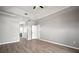 Spacious bedroom with tray ceilings, wood-look floors, and a walk-in closet offers simple elegance at 10101 Paddock Oaks Dr, Riverview, FL 33569