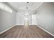 Bright bedroom boasts tray ceilings, wood-look floors, and ample natural light from a beautiful arched window at 10101 Paddock Oaks Dr, Riverview, FL 33569