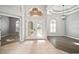 Home foyer featuring tile flooring, elegant double doors, and tray ceiling detail at 10101 Paddock Oaks Dr, Riverview, FL 33569