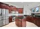 Kitchen featuring dark wood cabinetry, stainless steel appliances, and a functional center island at 10101 Paddock Oaks Dr, Riverview, FL 33569