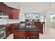 Spacious kitchen with dark cabinets, granite countertops, and a central island for food preparation at 10101 Paddock Oaks Dr, Riverview, FL 33569
