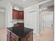 Well-lit kitchen with dark wood cabinets and granite island countertop at 10101 Paddock Oaks Dr, Riverview, FL 33569