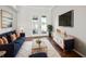 Bright living room with a blue sofa, entertainment center, and access to the outdoor pool area at 10101 Paddock Oaks Dr, Riverview, FL 33569
