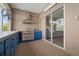 The outside patio features an outside kitchen with a stainless steel grill and custom blue cabinetry at 10101 Paddock Oaks Dr, Riverview, FL 33569