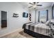 Comfortable bedroom with a ceiling fan, mounted TV, and neutral decor at 1031 Andrew Aviles Cir, Tampa, FL 33619