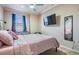Cozy bedroom with large window, ceiling fan, and mounted TV at 1031 Andrew Aviles Cir, Tampa, FL 33619