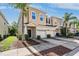 Inviting townhome boasts a well-manicured lawn, a one-car garage, and neutral-colored stucco at 1031 Andrew Aviles Cir, Tampa, FL 33619