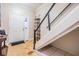 Bright foyer featuring unique flooring, modern floating shelving, and a white front door at 1031 Andrew Aviles Cir, Tampa, FL 33619