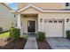 Charming home exterior featuring a tidy landscape and an attached garage at 1031 Andrew Aviles Cir, Tampa, FL 33619