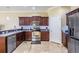 Stylish kitchen featuring stainless steel appliances, granite countertops, and dark wood cabinetry at 1031 Andrew Aviles Cir, Tampa, FL 33619