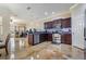 Open-concept kitchen featuring stainless steel appliances, granite countertops, and dark wood cabinetry at 1031 Andrew Aviles Cir, Tampa, FL 33619