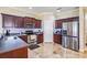 Modern kitchen boasts stainless steel appliances, granite countertops, and dark wood cabinetry at 1031 Andrew Aviles Cir, Tampa, FL 33619