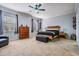 Serene main bedroom with a ceiling fan, two windows, and neutral carpet at 1031 Andrew Aviles Cir, Tampa, FL 33619