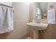 Classic powder room with pedestal sink, mirror, and neutral color scheme at 1031 Andrew Aviles Cir, Tampa, FL 33619