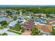 Aerial view of a residential neighborhood with mature trees, private pools and screened in enclosures at 10327 Meadow Crossing Dr, Tampa, FL 33647