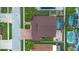 Aerial view of a single Gathering home with a screened pool, brick paver driveway, and well-maintained landscaping at 10327 Meadow Crossing Dr, Tampa, FL 33647