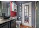 Charming bathroom featuring a unique vessel sink, built-in storage, and a door to the bedroom, combining style and functionality at 10327 Meadow Crossing Dr, Tampa, FL 33647