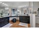 Modern bathroom with sleek black cabinets, dual vessel sinks, and a glass-enclosed shower, providing a spa-like experience at 10327 Meadow Crossing Dr, Tampa, FL 33647