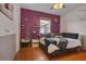 Whimsical bedroom with Paris theme, purple accent wall and ample natural light, perfect for a or guest room at 10327 Meadow Crossing Dr, Tampa, FL 33647